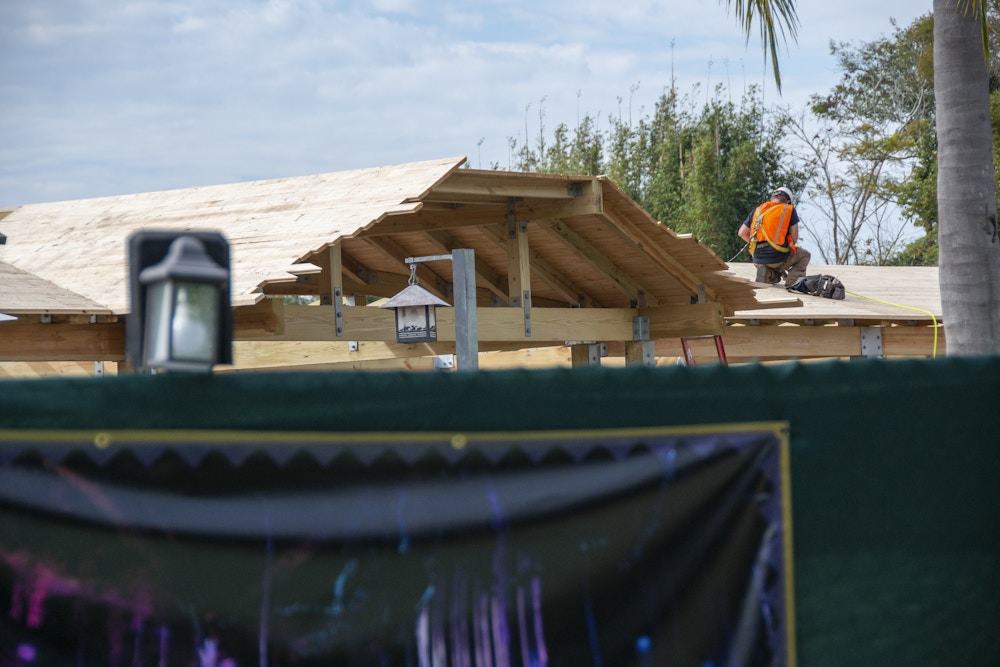 Animal Kingdom Entrance Construction 1 29 20 roof worker.jpg?auto=compress%2Cformat&fit=scale&h=667&ixlib=php 1.2