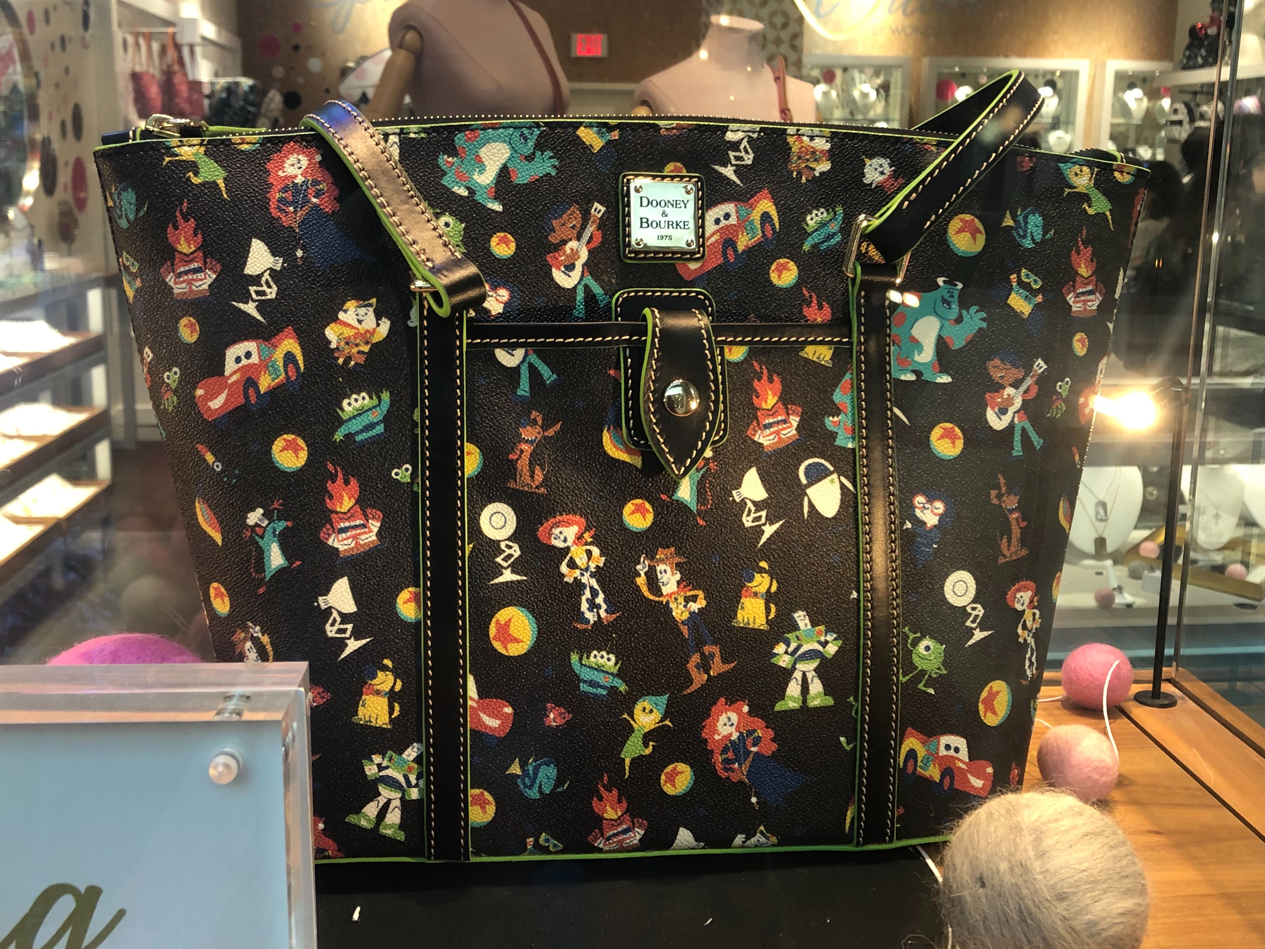 PHOTOS New “World of PIXAR” Dooney & Bourke Collection Coming Soon to