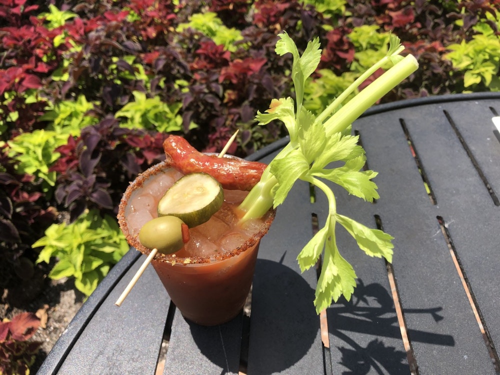 EPCOT Drinks _ Barbecue Bloody Mary with Smoked Garlic Sausage and House-made Pickle Skewer served with a Mustard and Barbecue Rub Rim